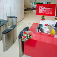 Red sofa and seating area in an office space, with a red 'Red Hat' sign on the wall