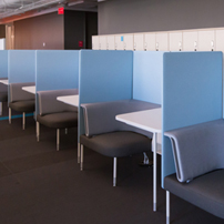 Row of individual study carrels or touchdown desks with light blue partitions