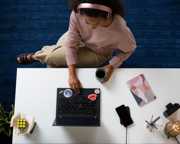 A woman uses her laptop, picture is from above