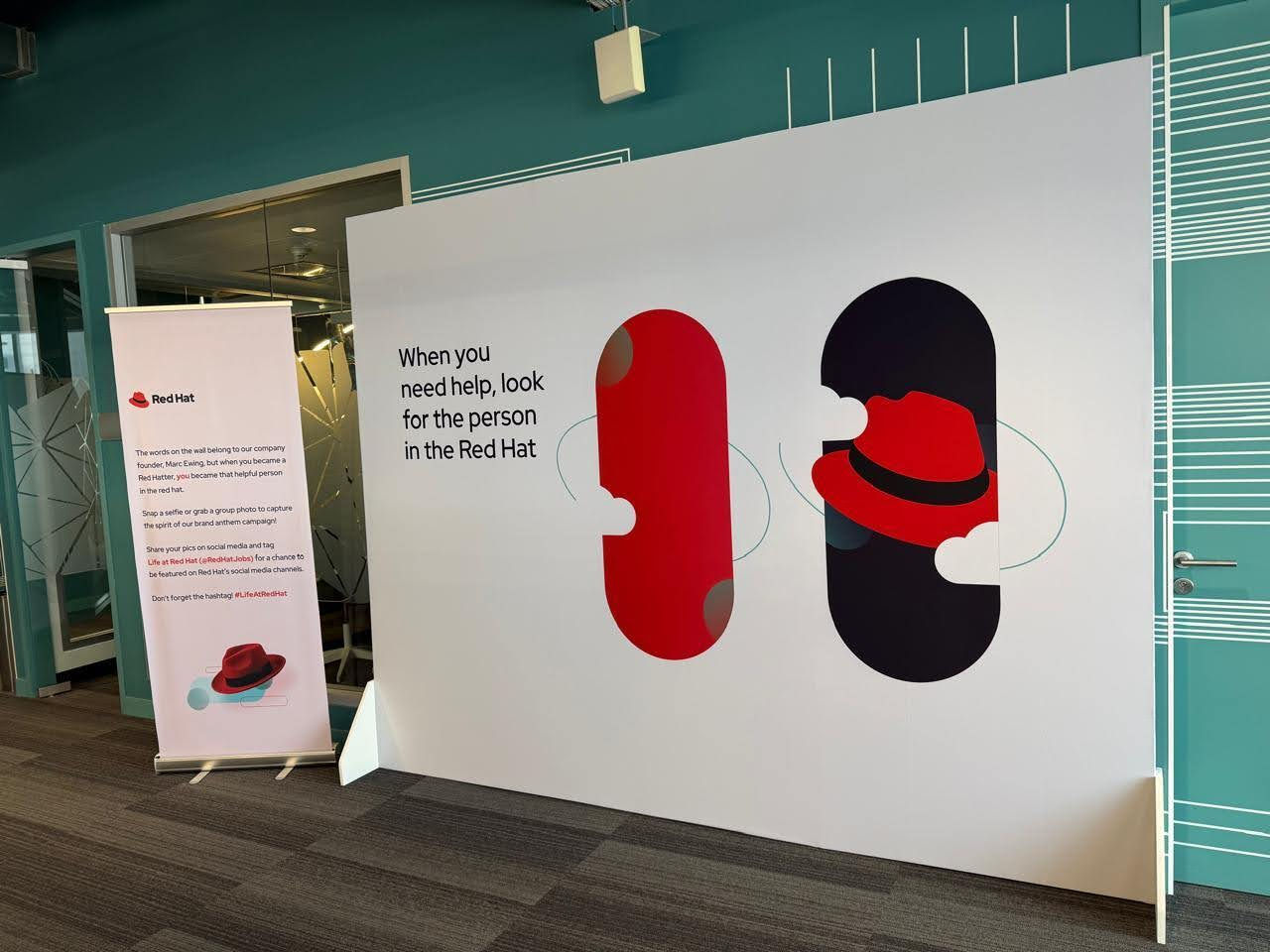 A large temporary sign with Red Hat branding