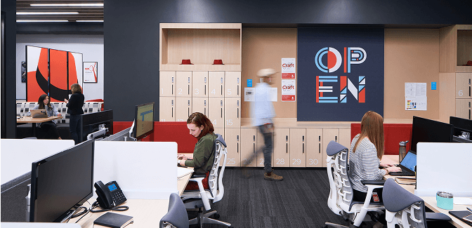 Modern open office with desks, lockers, and bold "OPEN" sign.