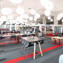 Modern cafeteria with round pendant lights.