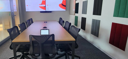 Small conference room with colorful acoustic panels.