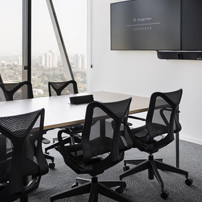 Conference room with grid ceiling and city view.