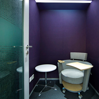 Small, private phone room with a purple accent wall