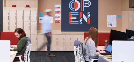 Office service point with an 'OPEN' sign, with extensive banks of lockers in the background